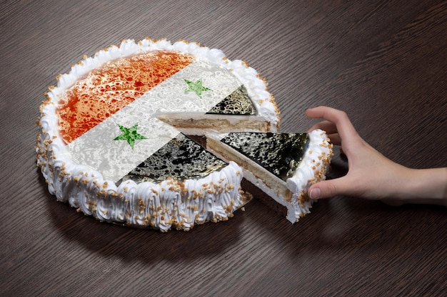 The symbol of war and separatism a cake with a picture of the flag of Syria is broken into pieces