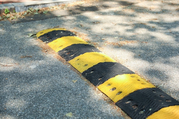 Photo a symbolic barrier on the road the street speed bump represents caution safety and the need to sl