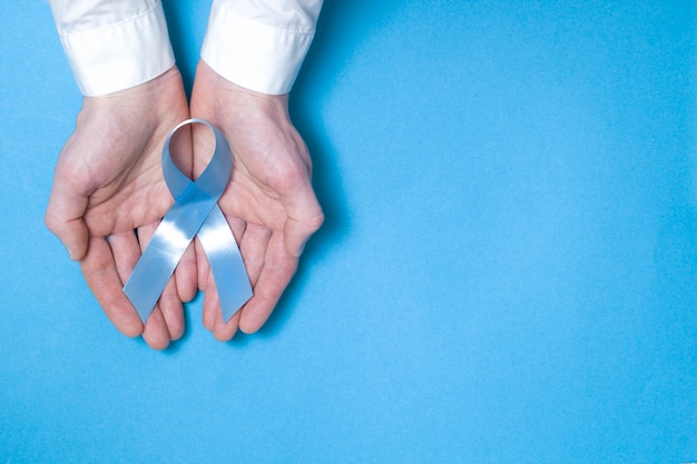 Symbolic blue ribbon. The problem of prostate cancer. Copy space. 