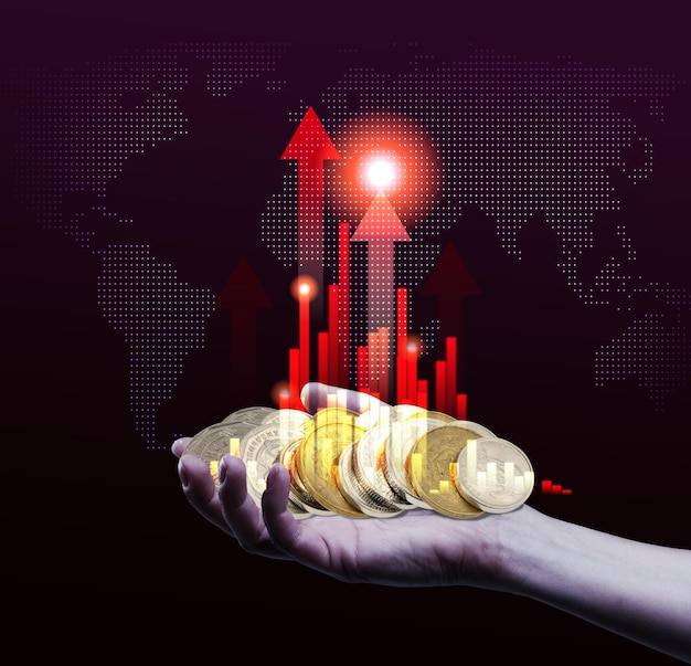 Symbolism of financial growth or success A hand holding a stack of golden coins with a red arrow pointing up against the background of a world map