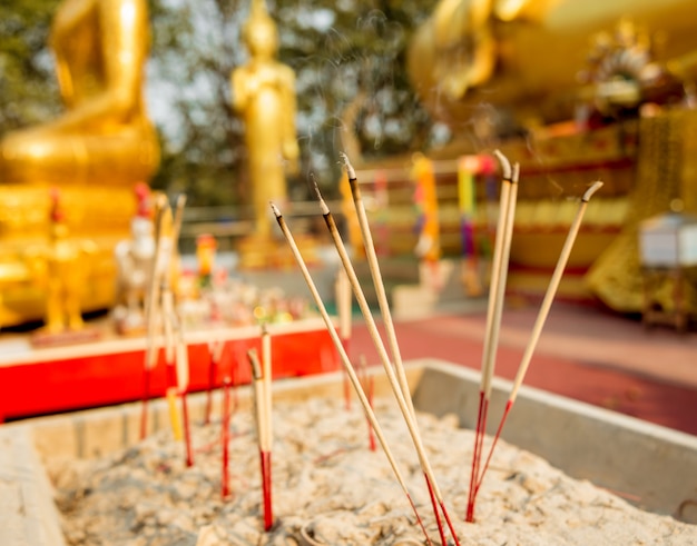 Symbols of Buddhism. Burning incense sticks. South-Eastern Asia. Details of buddhist temple in Thailand.