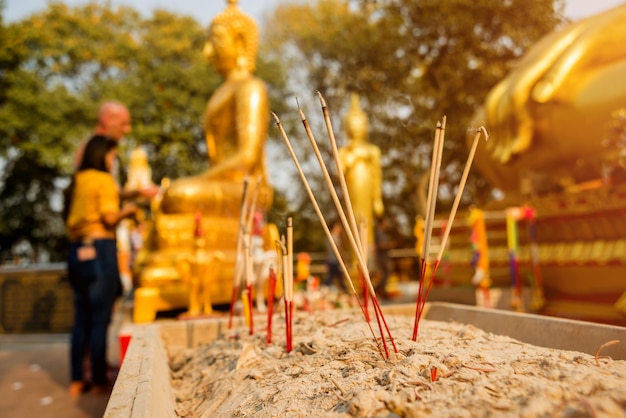 Symbols of Buddhism. Burning incense sticks. South-Eastern Asia. Details of buddhist temple in Thailand.