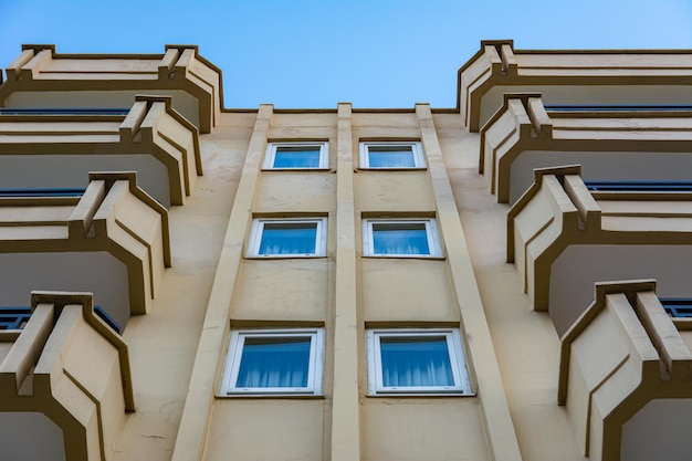 Symmetry of balconies and windows against the blue sky