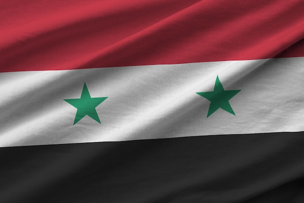 Syria flag with big folds waving close up under the studio light indoors the official symbols and co