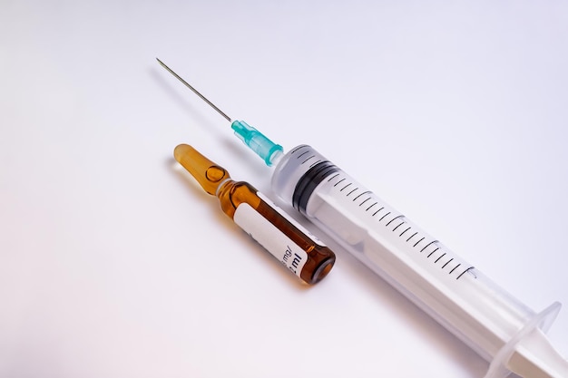 Syringe needle and a medication vial isolated on a white background