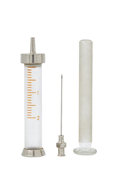 Syringe old disassembled into parts with glass piston and metal needle isolated on white background with clipping path