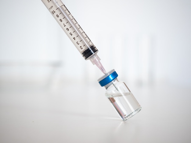 Syringe and vial, isolated on a white background. Prevention against diseases and viruses.