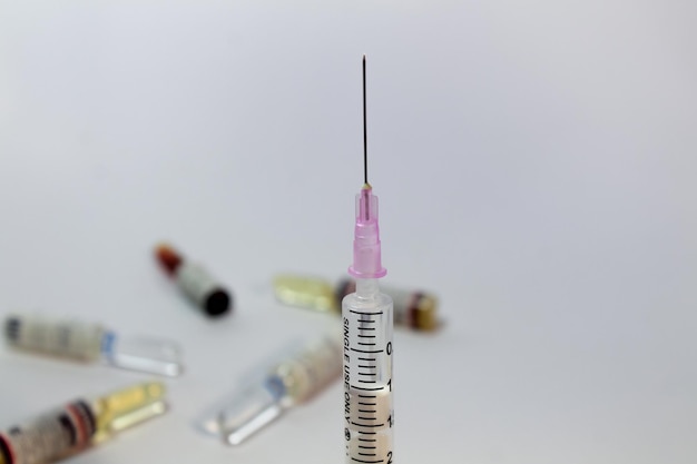 Syringe with blur ampule bottles background