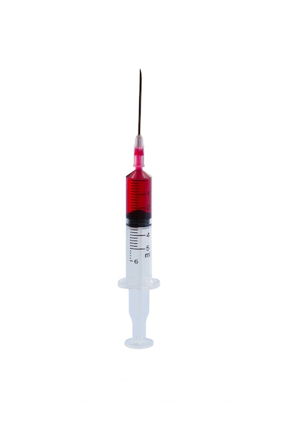 Syringe with drop red blood liquid isolated on white .