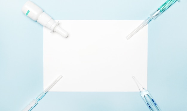 Syringes and a blank white sheet of paper