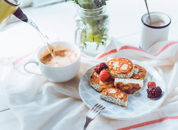 Syrniki with berries on a plate