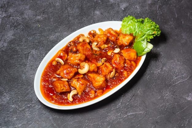 Szechuan Chicken Cashew Nut served in dish isolated on grey background top view of indian and bangladesh food