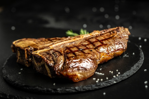 T-bone or aged wagyu porterhouse grilled beef steak with spices and herbs