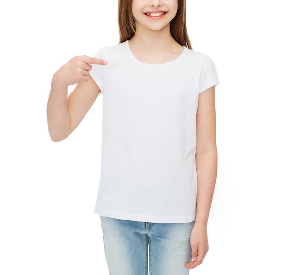 t-shirt design concept - smiling little girl in blank white t-shirt pointing at herself