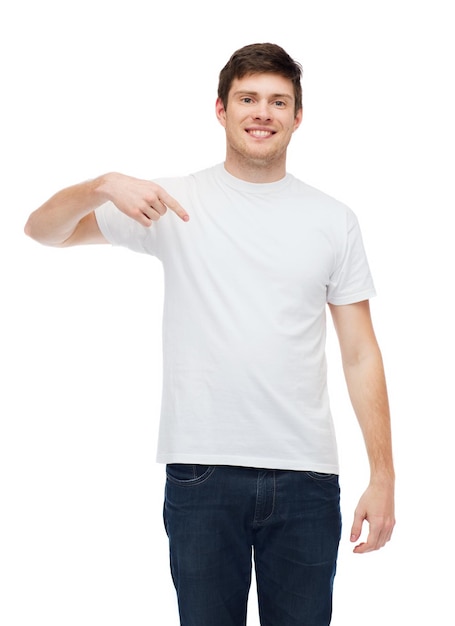 t-shirt design, gesture and people concept - smiling young man in blank white t-shirt pointing finger on himself