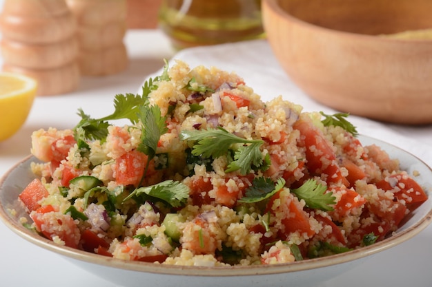 Tabbouleh a Middle Eastern cuisine vegetarian salad with chopped parsley tomatoes mint onion and bulgur and seasoned with olive oil lemon juice