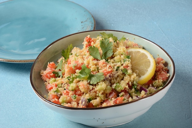 Tabbouleh a Middle Eastern cuisine vegetarian salad with chopped parsley tomatoes mint onion and bulgur and seasoned with olive oil lemon juice