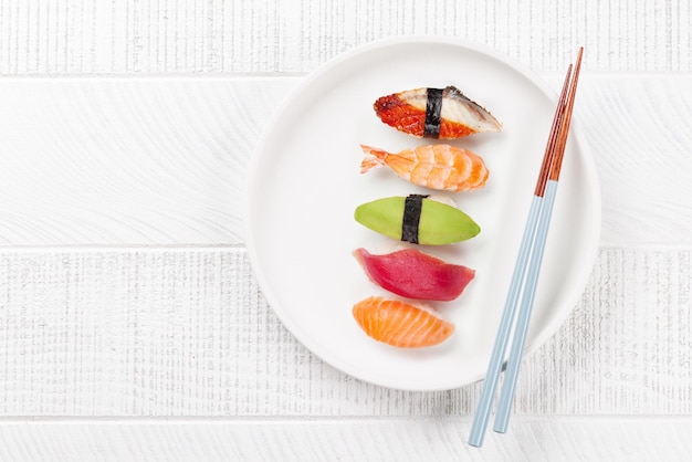 Photo table adorned with cherry blossom branch and chopsticks epitomizing japanese food culture