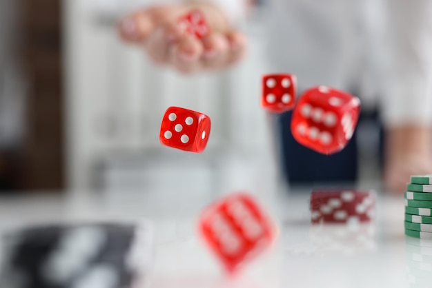 On the table are red dice and green casino chips