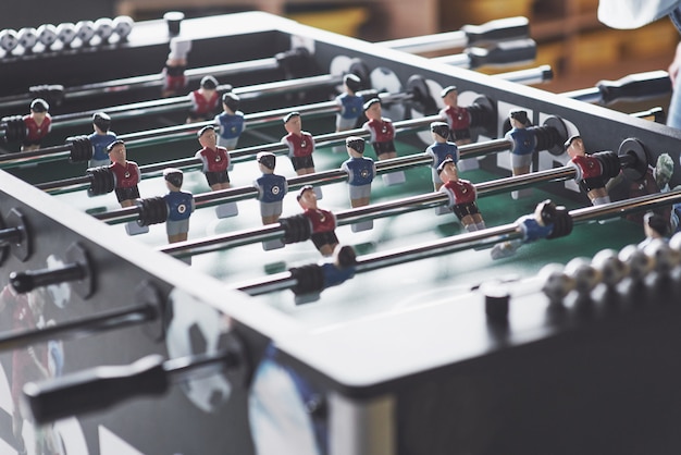 Table football in the entertainment center. Close-up image of plastic players in a football game