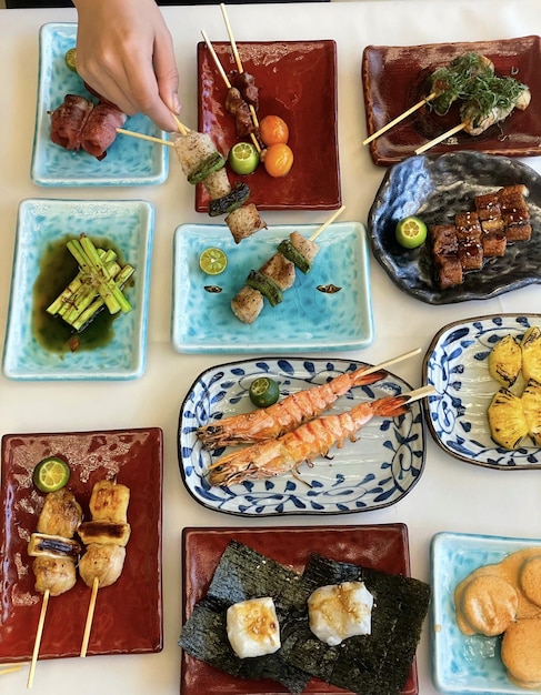 A table full of plates with different foods including shrimp, shrimp, and other food.