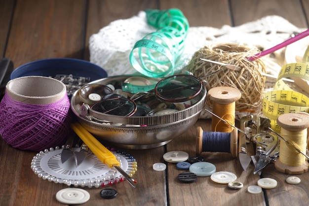 A table full of sewing supplies including a sewing machine, a sewing machine, a sewing machine, and a sewing machine.