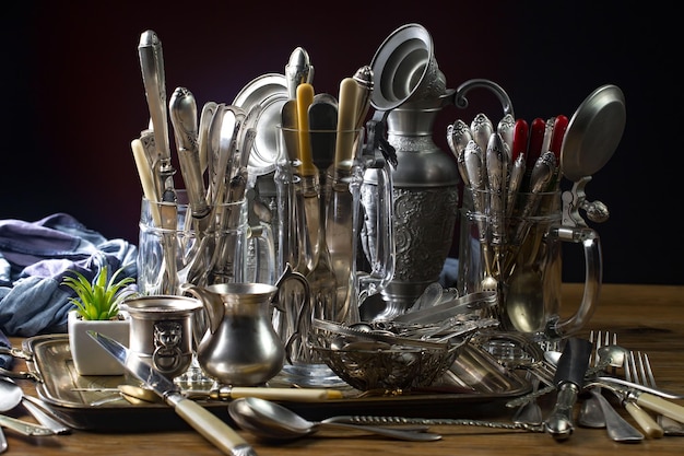 A table full of silverware and other items including a silverware.