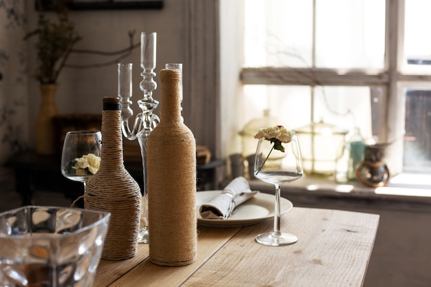 Table serving with bottles and wineglass against the big window. Space for text