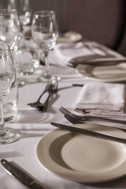 Table set for dinner service with white linen