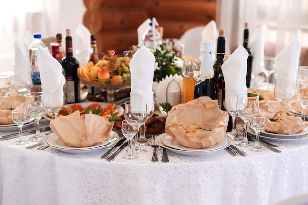 Table set with light snacks, canapes and glasses