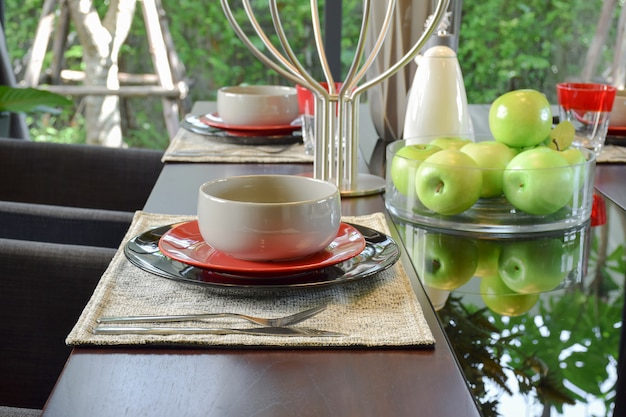 Table set on wooden dining table in modern style dining room interior