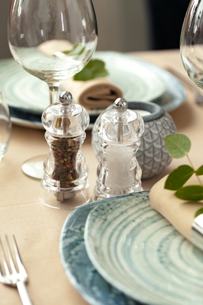 Table setting set with candles and plant branches