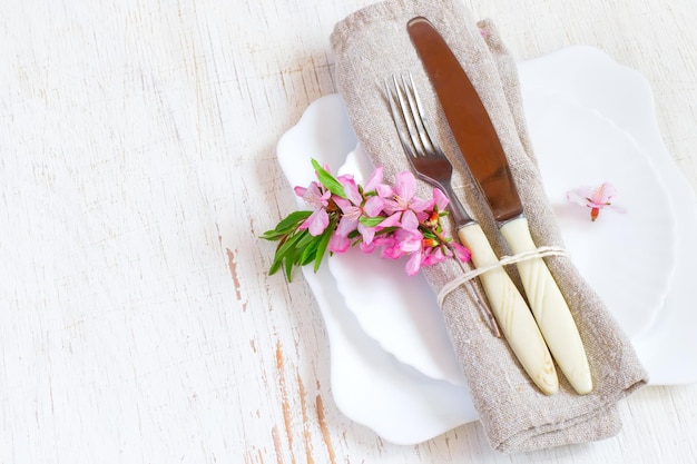 Table setting with flowering almonds. Spring white background.