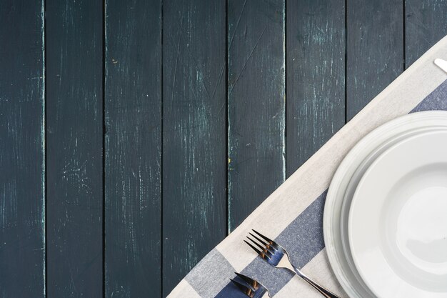 Table setup with plates on dark wooden background