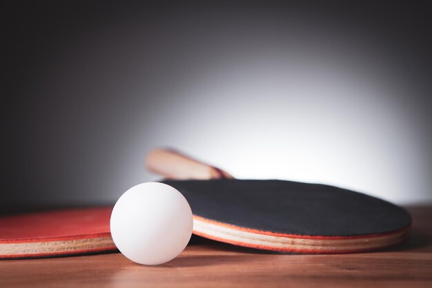 Table tennis rackets and a white plastic balls