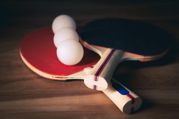 Table tennis rackets and a white plastic balls