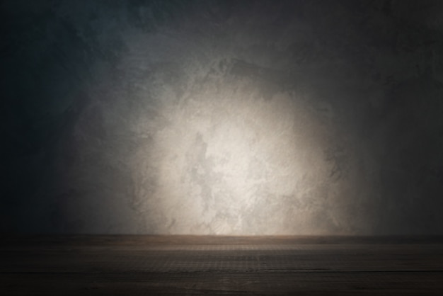 Table top on concrete wall with ray of light