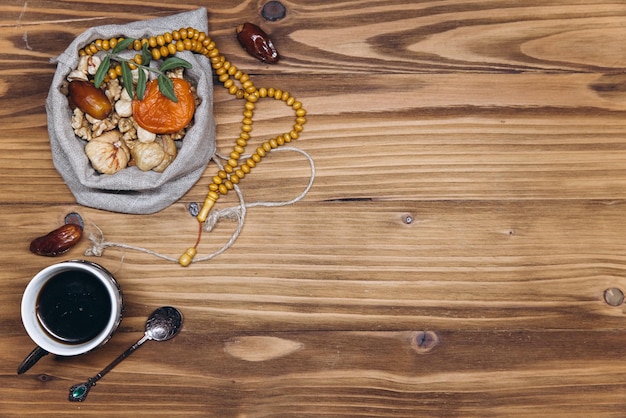 Table top view image of decoration Ramadan Kareem dates fruit cup of coffee and almond