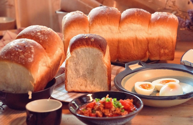 A table with bread and a bowl of eggs