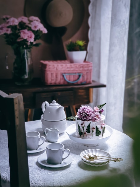 A table with a cake and a basket of flowers on it