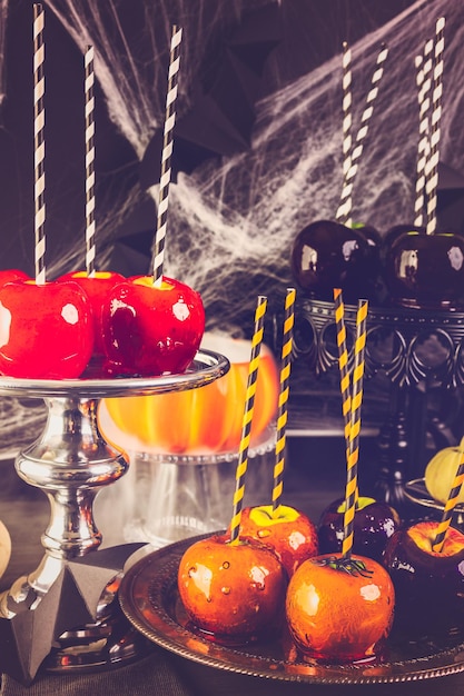 Table with colored candy apples for Halloween party.