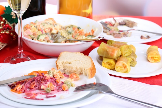 Table with festive dishes after feast close-up