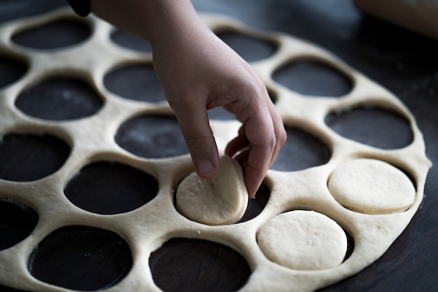 Table with homemade donuts during process