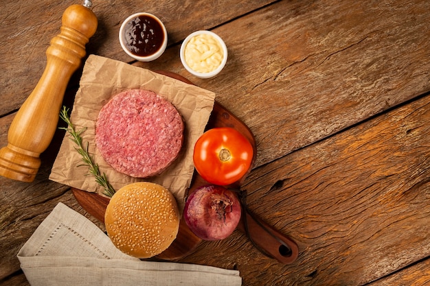 Photo table with ingredients for hamburger raw hamburger