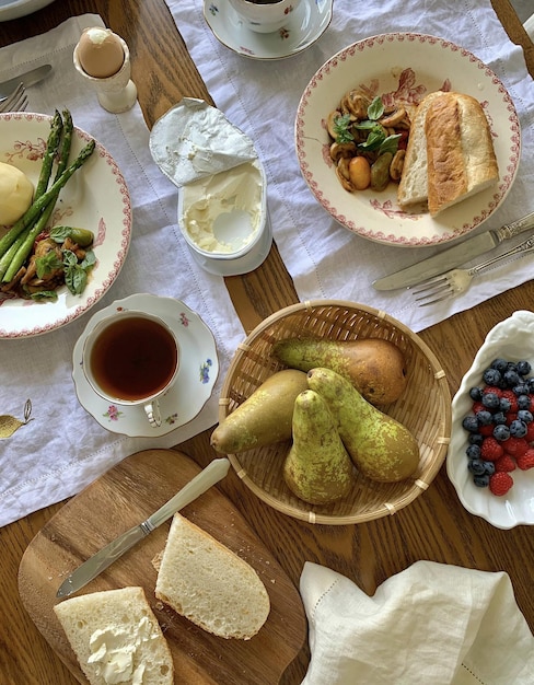 A table with a plate of food and a cup of tea on it