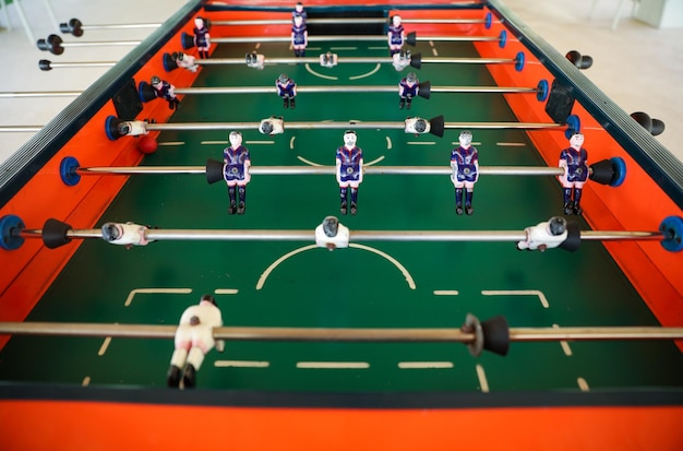 A table with a soccer field and a number of people on it