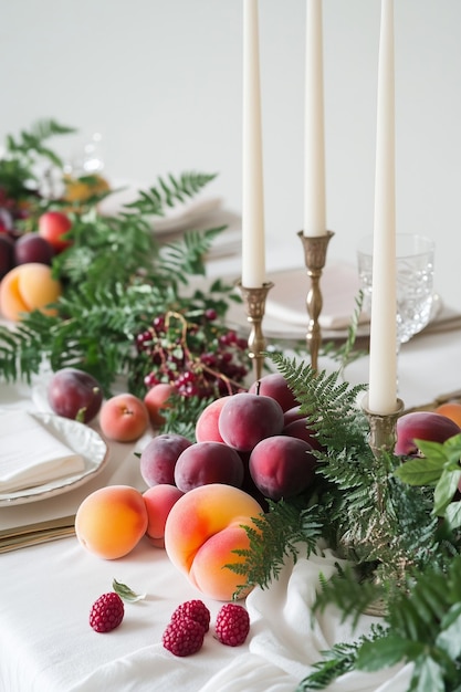 a table with a tray of fruit and a candle on it