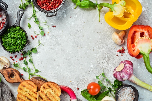 Table with vegetables spices and condiments Preparation for cooking On a stone background Top view