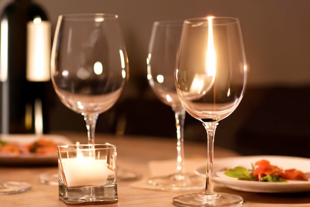 A table with wine glasses and a candle on it