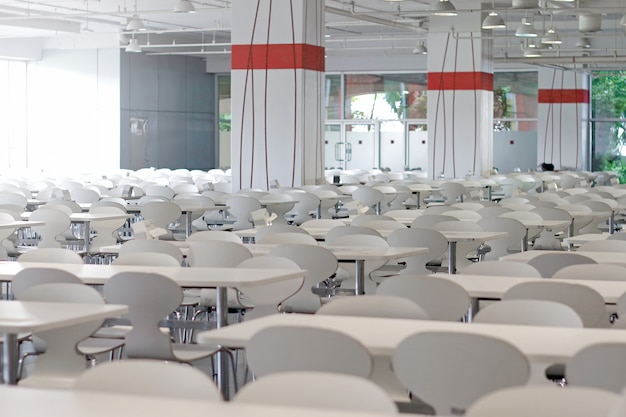 Tables and chairs on food court shopping mall. 